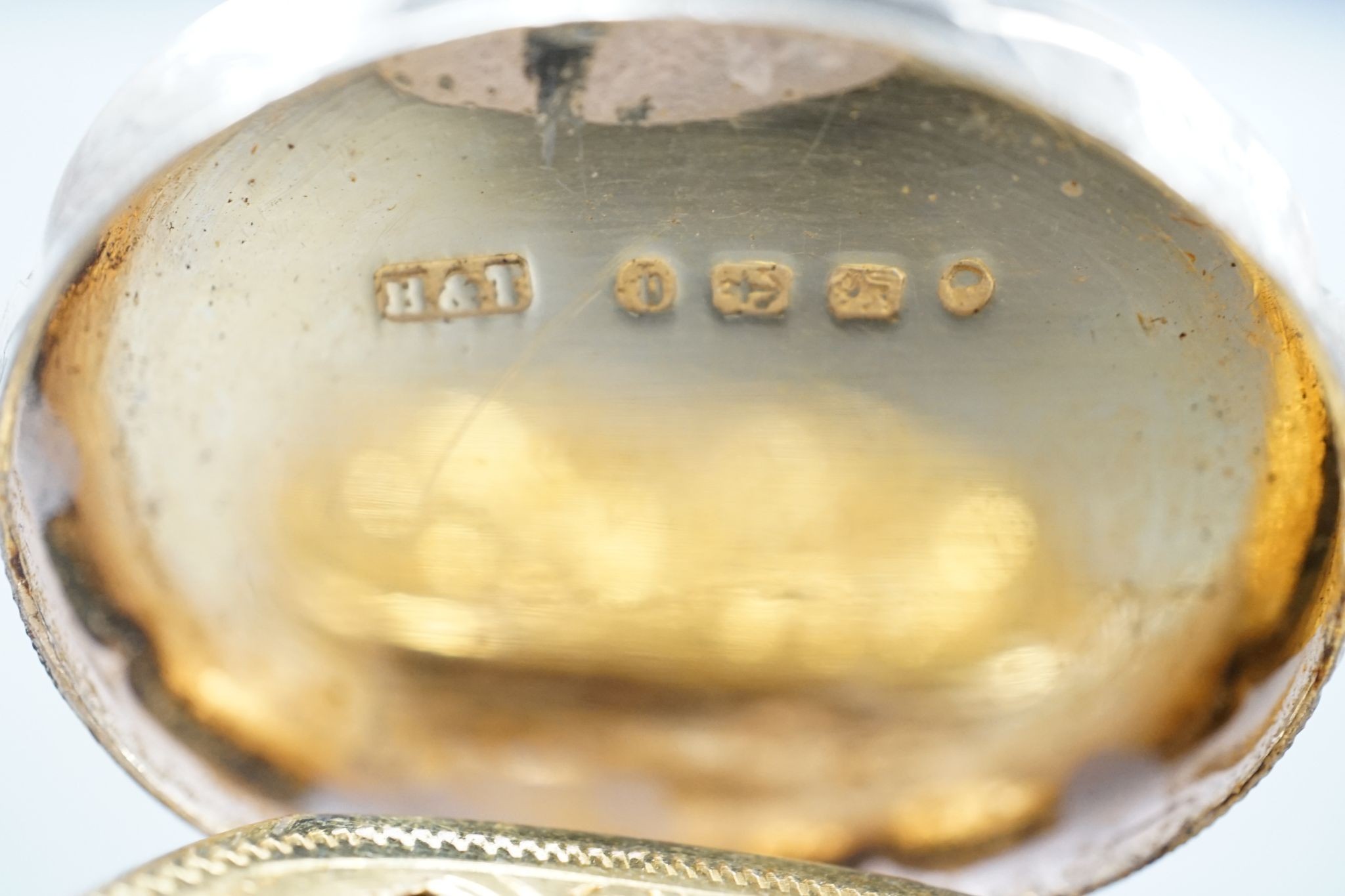 A Victorian engraved silver cusped oval vinaigrette, Hilliard & Thomasson, Birmingham, 1882, 39mm and a larger vinaigrette by George Unite, with engraved inscription.